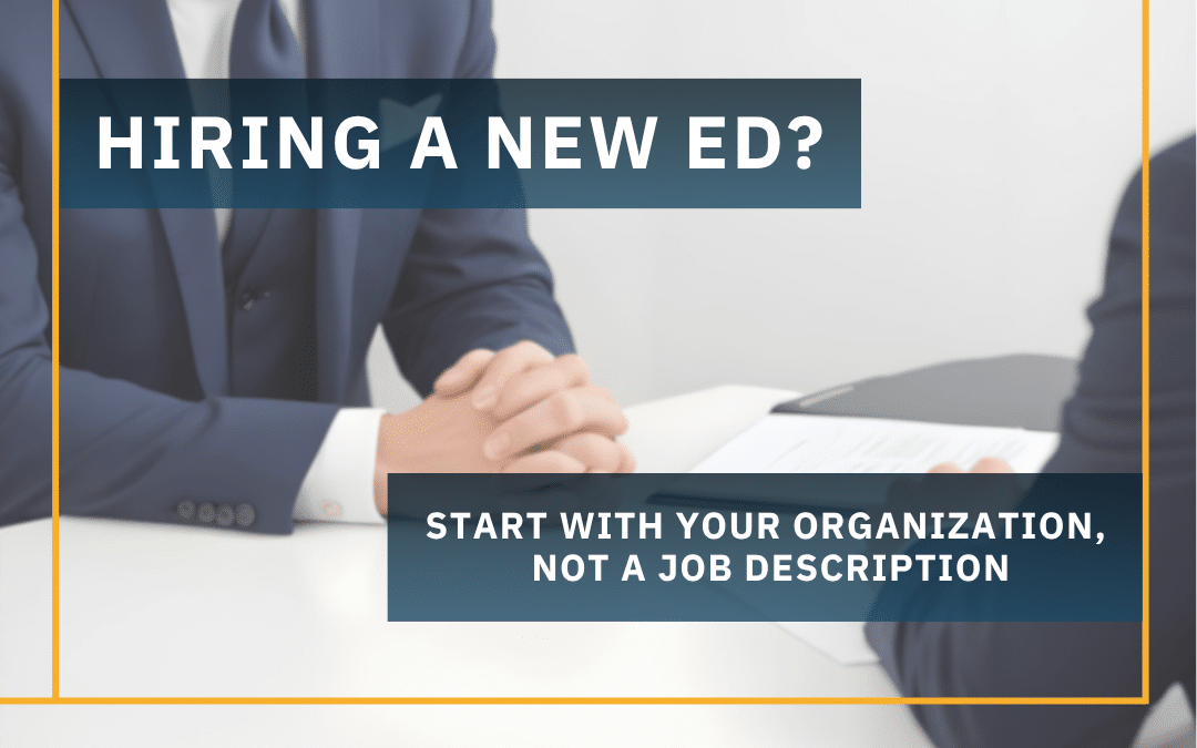 Text overlay reading 'Hiring a New ED? Start with your organization, not a job description' over a blurred image of two professionals in a job interview setting