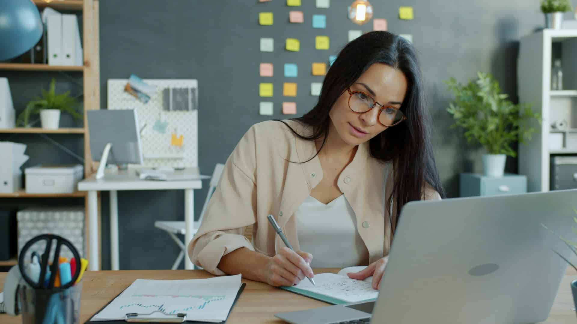 A focused nonprofit executive director working at her desk, representing the challenge of inheriting an unaligned board