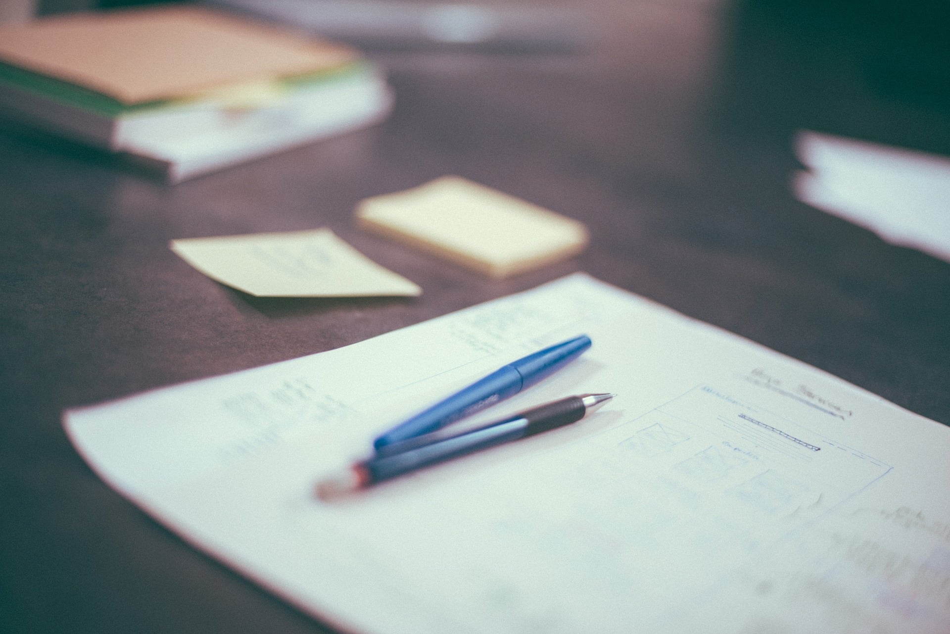 ebersmith-nonprofit-board-governance-playbook-documents A close-up of executive governance documents and pens on a modern desk, representing the deliverables included in the Inherited Board™ New ED program by ebersmith coaching & consulting